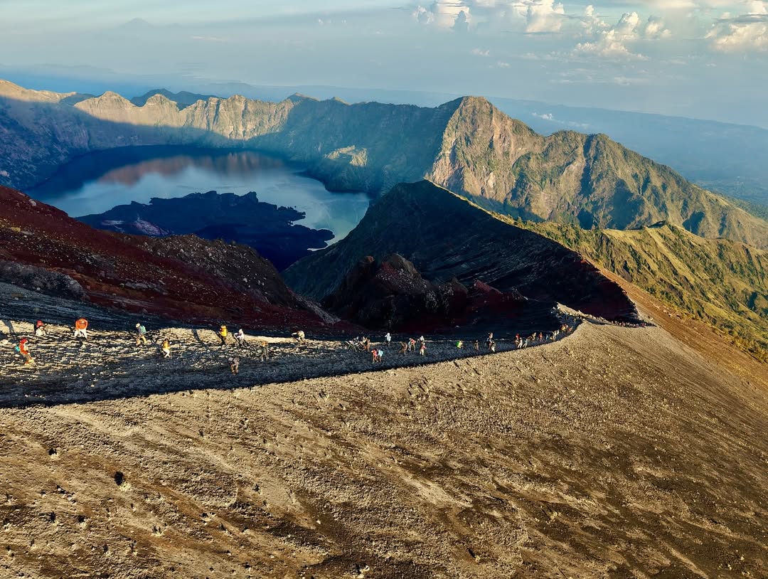 Mount Rinjani's Segara Anak Crater Lake viewed from the trekking trail, one of the most popular highlights of hiking adventures in Lombok, Indonesia.