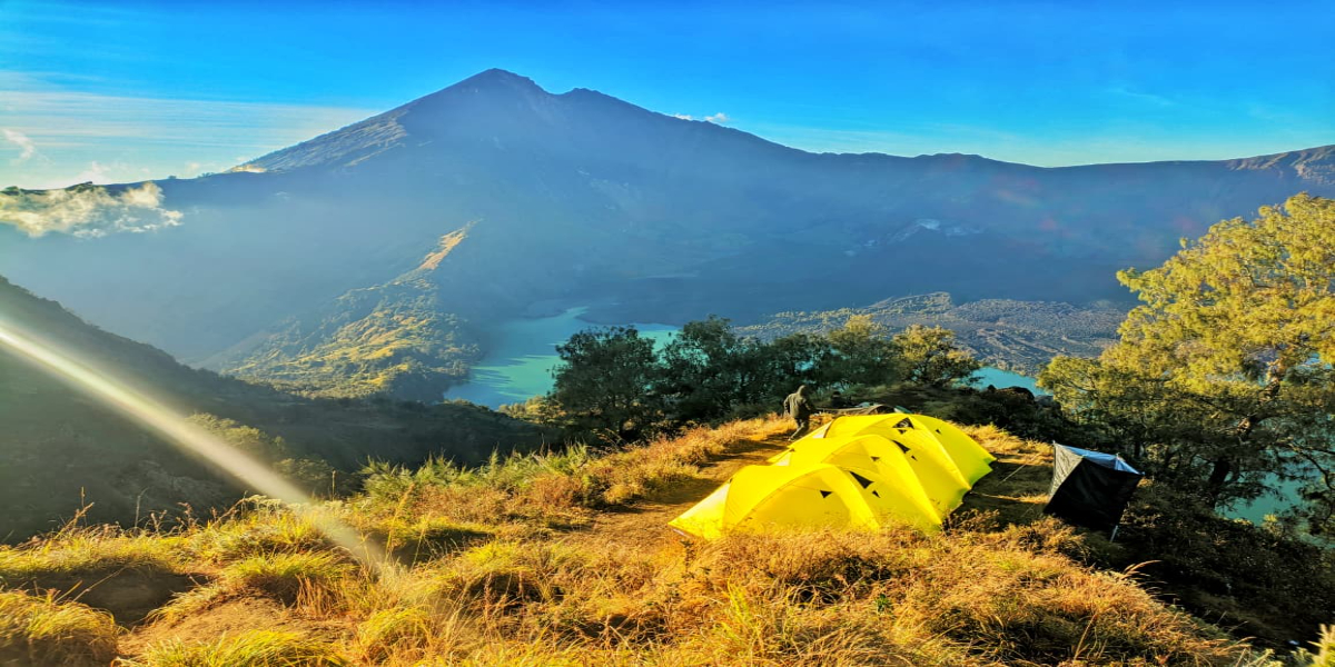 Mount Rinjani trekking trail in Lombok, Indonesia, with panoramic views of Segara Anak Lake and the surrounding volcanic landscape.